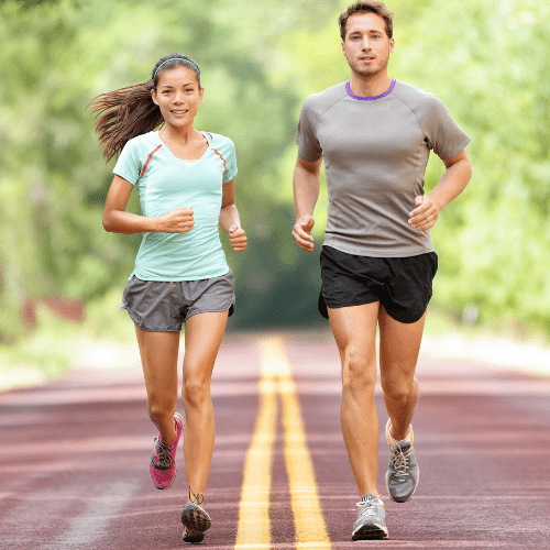 A man and woman running on the road