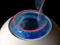 A blue bowl with a pink swirl in it.